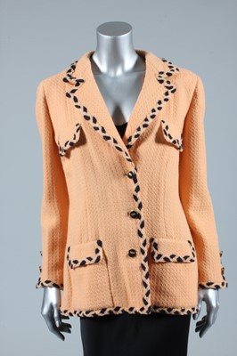 Lot 201 - A Chanel couture salmon-pink wool jacket, late...