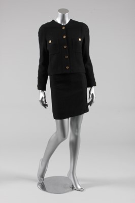 Lot 203 - A Chanel black bouclé tweed suit, 1980s,...