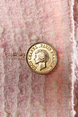 Lot 207 - A Chanel pink tweed suit, 1980s, boutique...