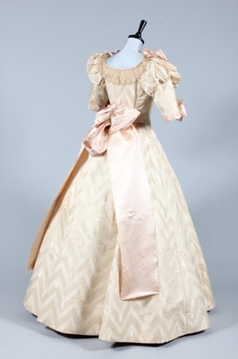 Lot 34 - An ivory damask ball/bridal gown, circa 1895,...