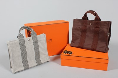 Lot 54 - Two Hermès hoppers, one grey, the other brown...