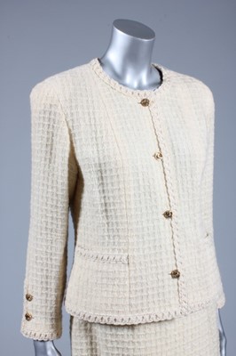 Lot 73 - A Chanel cream wool suit, 1970s, boutique...