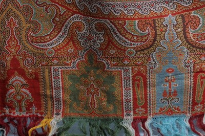 Lot 83 - A woven wool shawl of Paisley design, circa...