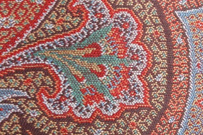 Lot 83 - A woven wool shawl of Paisley design, circa...