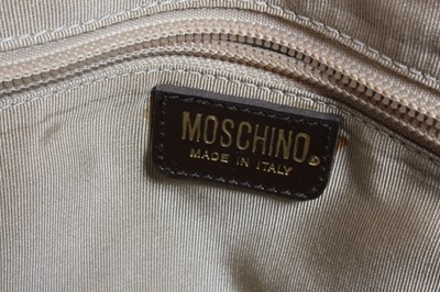 Lot 12 - A Moschino 'Fudge the Fashionistas, Let them...