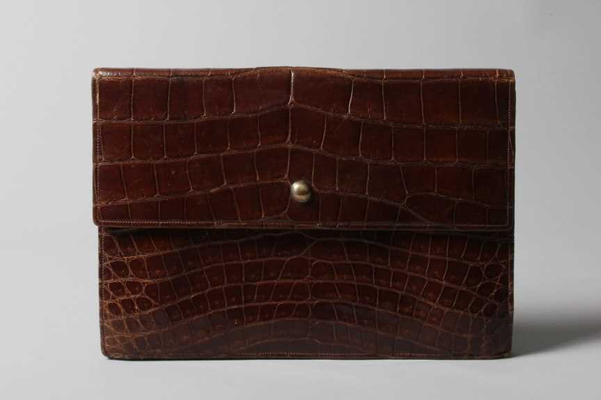 Lot 18 - A Cartier dark brown crocodile clutch bag,...