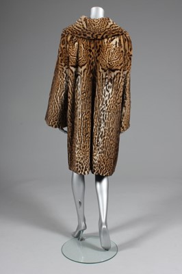 Lot 90 - An ocelot swing coat, late 1950s, with shawl...