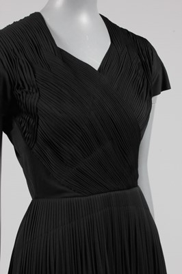 Lot 55 - A Madame Grès black jersey cocktail dress,...