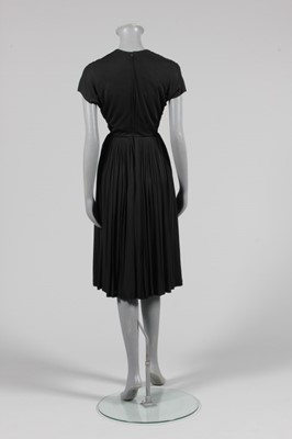 Lot 55 - A Madame Grès black jersey cocktail dress,...
