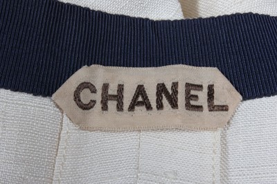 Lot 81 - A Chanel couture ivory slubbed silk suit,...