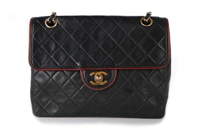 Lot 323 - A Chanel quilted navy leather flap bag, 1980s,...