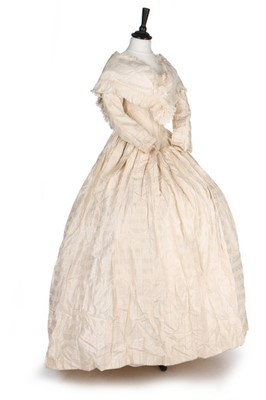 Lot 177 - An ivory silk bridal gown, circa 1845,...