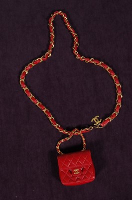 Lot 151 - A Chanel red quilted leather mini handbag,...