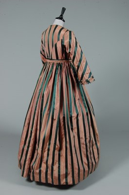 Lot 220 - A striped taffeta and satin gown, 1850s, but...