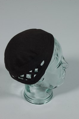 Lot 227 - A Chanel black stockinette skull cap, 1930s,...