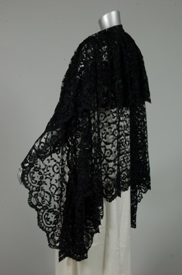 Lot 293 - A black imitation Chantilly triangular shawl,...