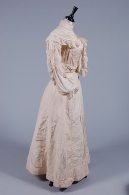 Lot 414 - An ivory damask taffeta bridal gown, 1901,...