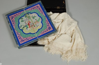 Lot 75 - An embroidered ivory silk shawl in original...