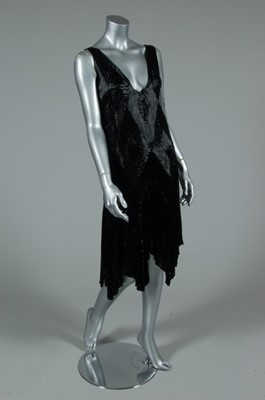 Lot 102 - An elaborate black beaded cocktail dress, late...