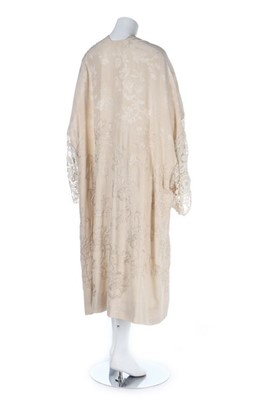 Lot 100 - An ivory silk damask kimono-style robe, 1920s,...