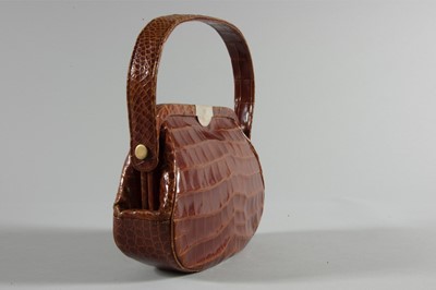 Lot 104 - An alligator handbag, bearing the cypher of...