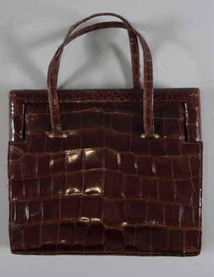 Lot 92 - A brown alligator handbag, circa 1947-50,...