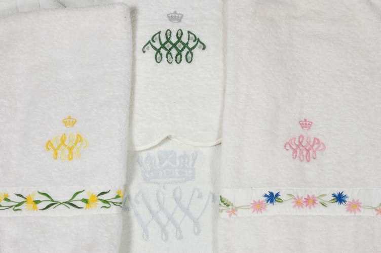 Lot 119 - Three hand towels and a bath mat bearing the...