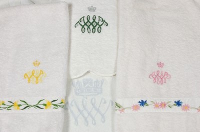 Lot 119 - Three hand towels and a bath mat bearing the...