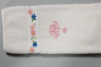 Lot 119 - Three hand towels and a bath mat bearing the...