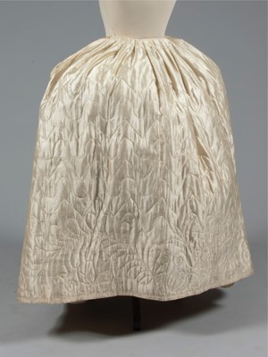Lot 49 - A quilted ivory silk petticoat, circa 1760-80,...