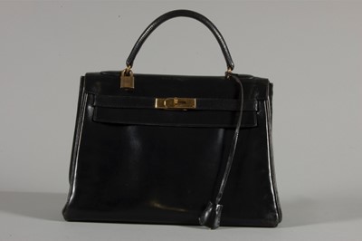 Lot 7 - An Hermès black leather Kelly bag, circa 1960,...