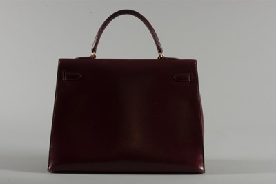 Lot 3 - A large Hermès burgundy leather Kelly bag,...