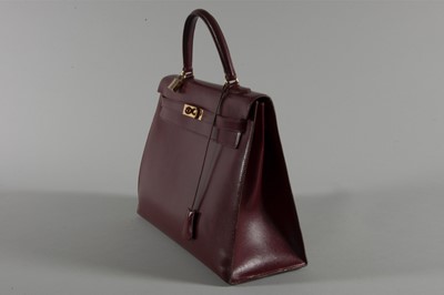 Lot 3 - A large Hermès burgundy leather Kelly bag,...