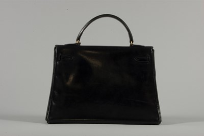 Lot 15 - An Hermès black box-leather Kelly bag, 1960s,...