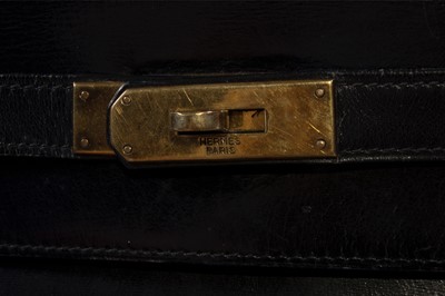 Lot 15 - An Hermès black box-leather Kelly bag, 1960s,...