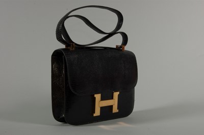Lot 11 - An Hermès black lizard 'Constance' bag, 1972,...