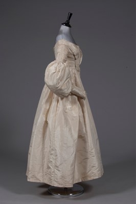 Lot 56 - An ivory silk bridal gown, circa 1838, with...