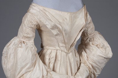 Lot 56 - An ivory silk bridal gown, circa 1838, with...