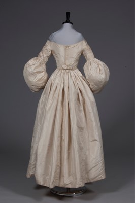 Lot 56 - An ivory silk bridal gown, circa 1838, with...