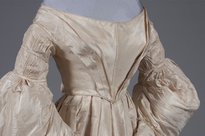 Lot 56 - An ivory silk bridal gown, circa 1838, with...