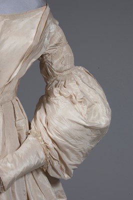 Lot 56 - An ivory silk bridal gown, circa 1838, with...