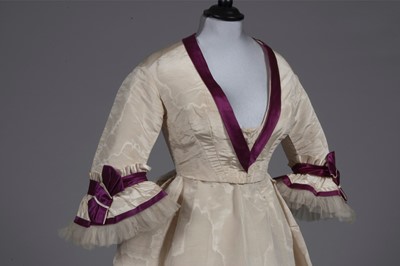 Lot 48 - A fine ivory moiré and wine satin gown with...