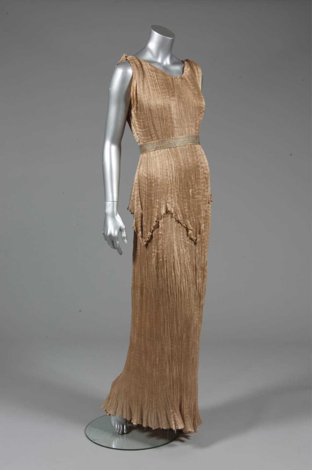 Lot 73 - A Mariano Fortuny apricot silk Peplos gown,...