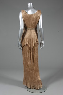 Lot 73 - A Mariano Fortuny apricot silk Peplos gown,...