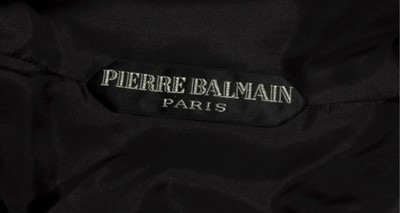 Lot 137 - A Pierre Balmain black bouclé wool dinner gown,...