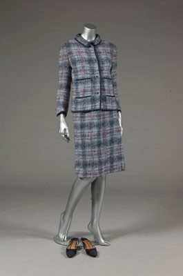 Lot 142 - A Chanel couture blue tweed suit, 1964,...
