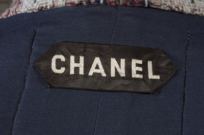 Lot 142 - A Chanel couture blue tweed suit, 1964,...