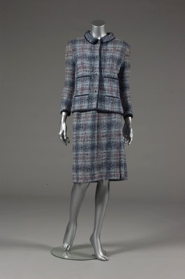 Lot 142 - A Chanel couture blue tweed suit, 1964,...