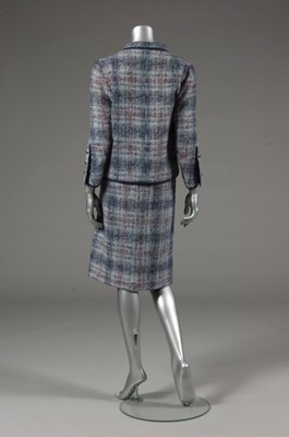 Lot 142 - A Chanel couture blue tweed suit, 1964,...