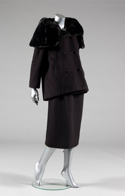 Lot 134 - A Balenciaga couture black wool suit with fur...
